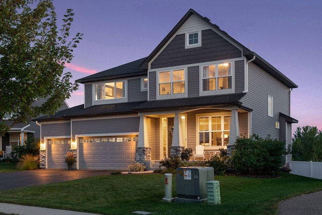 craftsman house with covered porch, driveway, and a garage