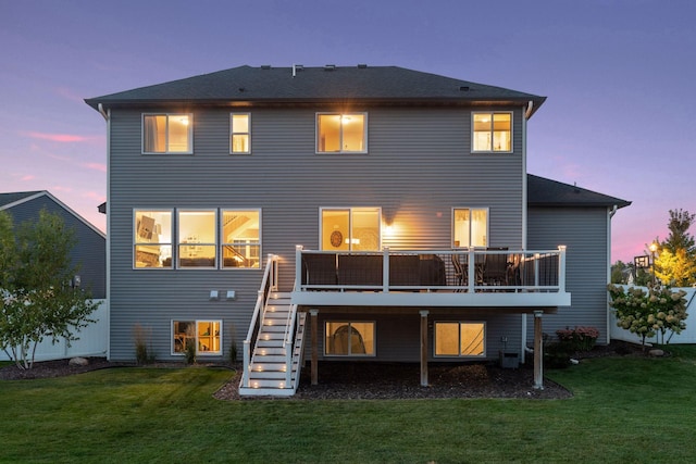 rear view of house with stairway, a yard, a wooden deck, and cooling unit