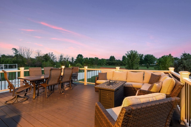 wooden deck with outdoor dining space, an outdoor hangout area, and view of scattered trees