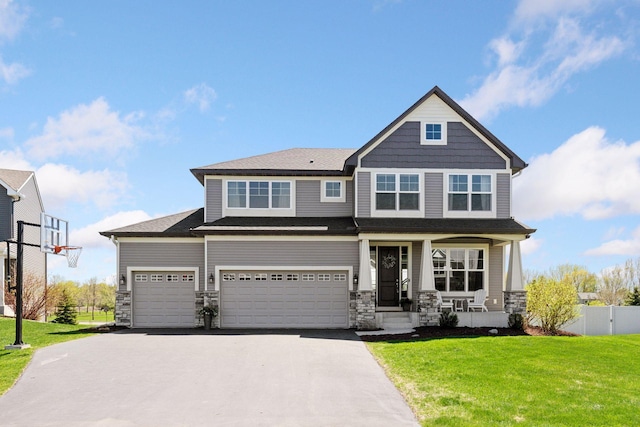 craftsman house with asphalt driveway, stone siding, covered porch, and an attached garage