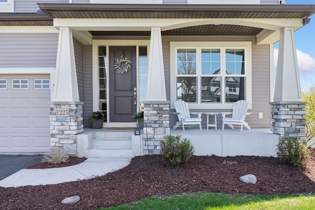 entrance to property with covered porch and stone siding