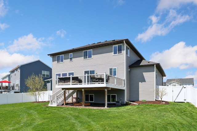 back of property with a deck, stairs, and a gate