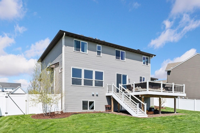 rear view of property featuring a gate, a wooden deck, and stairs