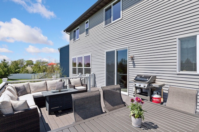 wooden terrace with outdoor lounge area, a grill, fence, and outdoor dining space