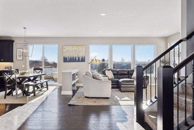 living area featuring healthy amount of natural light, hardwood / wood-style floors, stairs, a chandelier, and recessed lighting