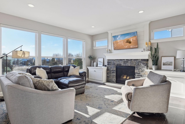 living room with wood finished floors, a fireplace, and recessed lighting