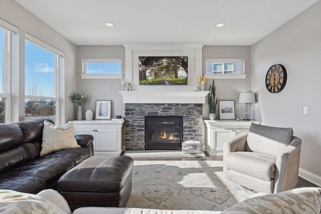 living area with wood finished floors, a fireplace, baseboards, and recessed lighting