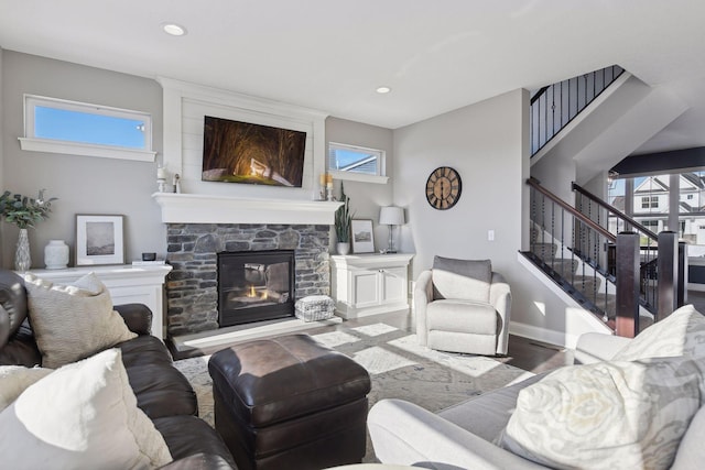 living room with wood finished floors, a fireplace, recessed lighting, baseboards, and stairs