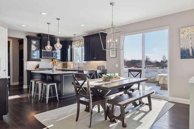 dining area featuring dark wood-style flooring, recessed lighting, baseboards, and a chandelier