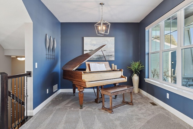 living area featuring a chandelier, carpet, and baseboards