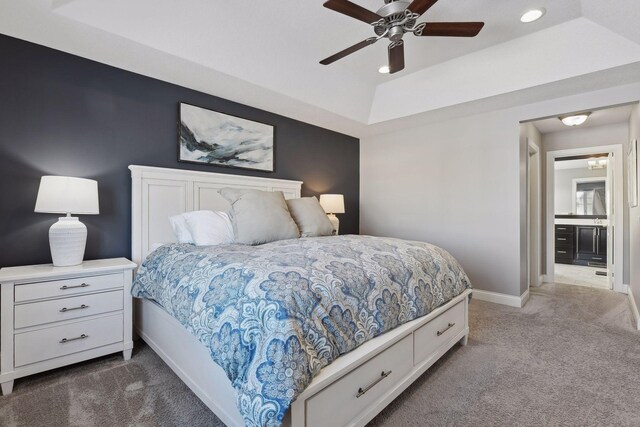 bedroom with dark colored carpet, a raised ceiling, baseboards, recessed lighting, and a ceiling fan
