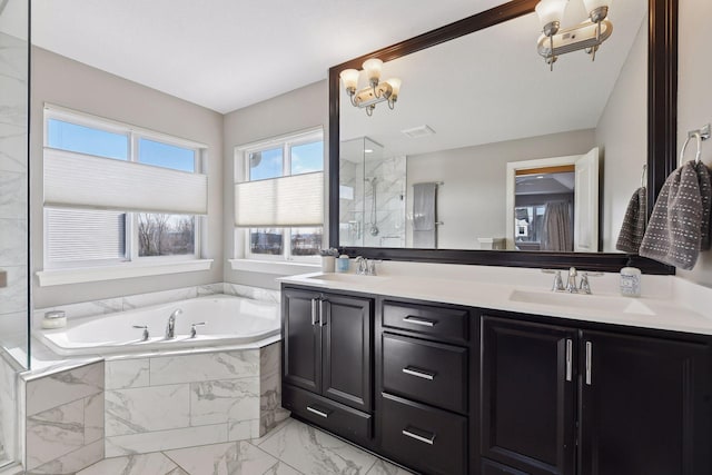 bathroom featuring marble look tile flooring, a shower stall, a bath, double vanity, and a chandelier