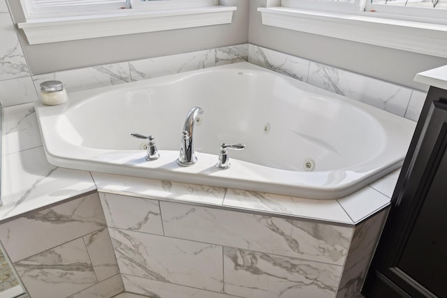 full bath with a tub with jets