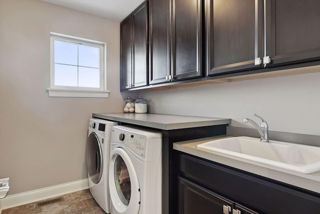 laundry room with cabinet space, washing machine and clothes dryer, and baseboards