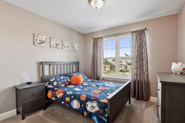 carpeted bedroom with baseboards and a textured ceiling