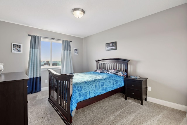 bedroom featuring carpet floors and baseboards