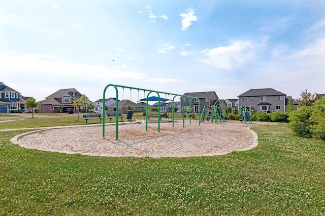 communal playground featuring a residential view and a yard