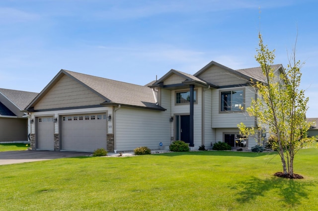 view of front of property with a front lawn and a garage