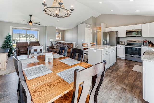 dining room with ceiling fan with notable chandelier, high vaulted ceiling, and dark hardwood / wood-style flooring