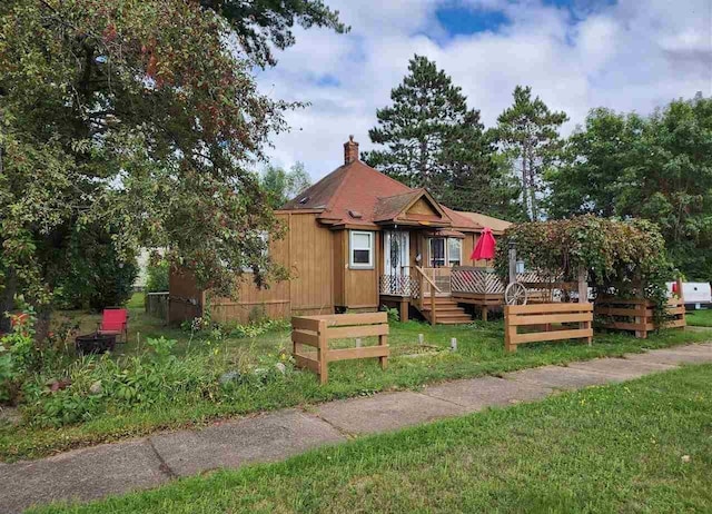 view of front of house with a front lawn and a wooden deck