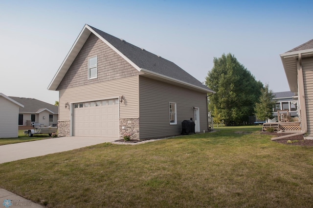 view of home's exterior with a garage and a yard