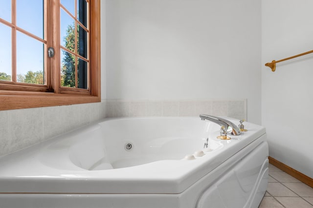 bathroom with tile patterned floors and a bathtub