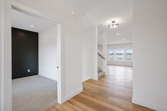 hallway with light hardwood / wood-style floors