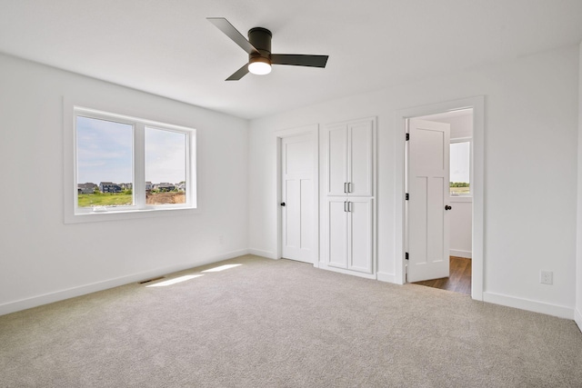 unfurnished bedroom featuring carpet and ceiling fan