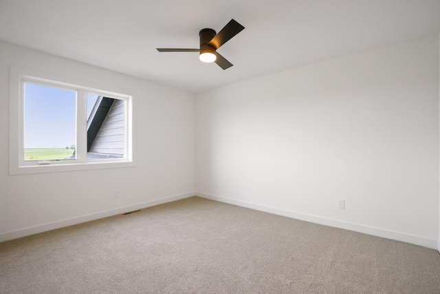 carpeted empty room featuring ceiling fan