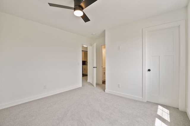 unfurnished bedroom featuring light carpet and ceiling fan