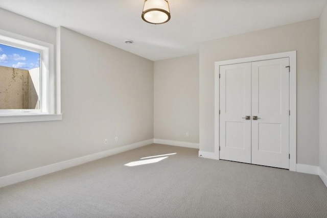 unfurnished bedroom with carpet flooring and a closet