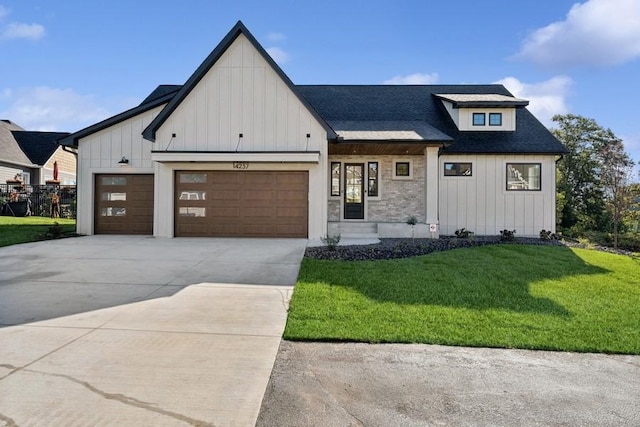 modern inspired farmhouse featuring a front lawn and a garage