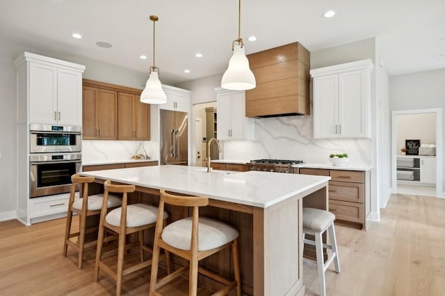 kitchen featuring white cabinets, pendant lighting, a spacious island, and custom exhaust hood