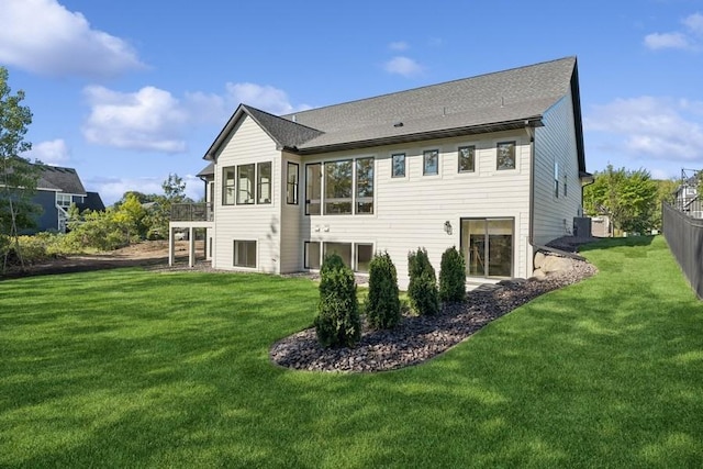 rear view of property with a lawn