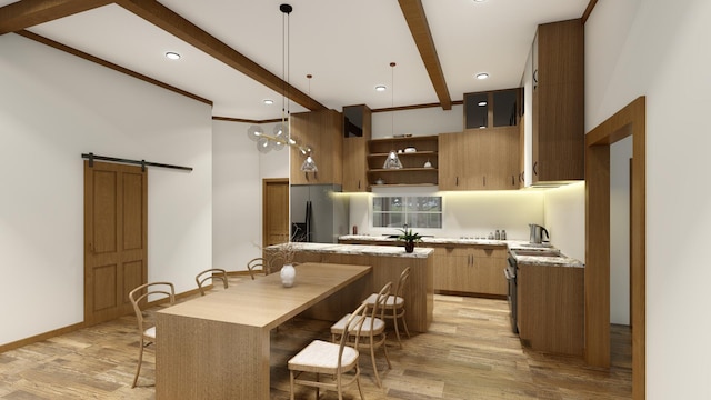 kitchen featuring beam ceiling, a barn door, light hardwood / wood-style flooring, stainless steel fridge, and pendant lighting