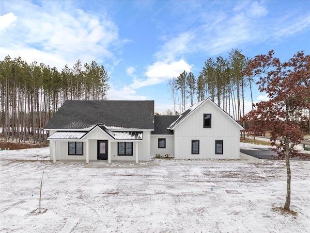 view of snow covered rear of property