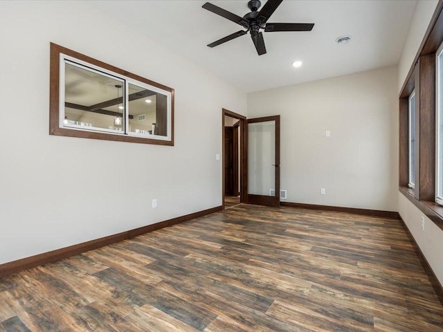 unfurnished room with ceiling fan and dark wood-type flooring