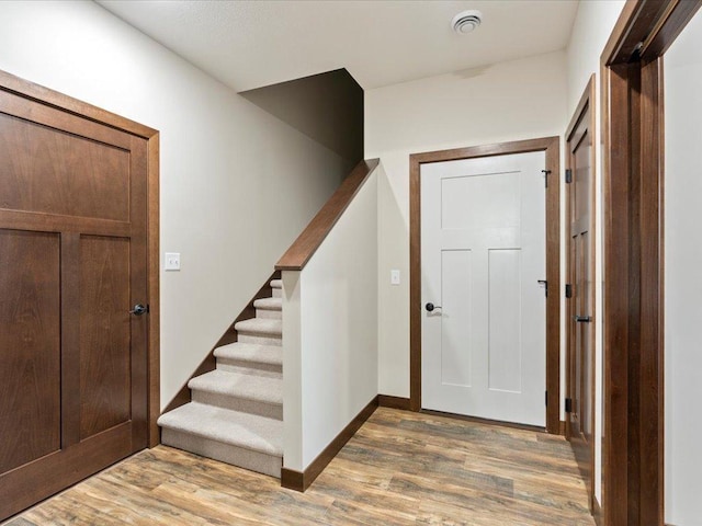 entryway with hardwood / wood-style flooring