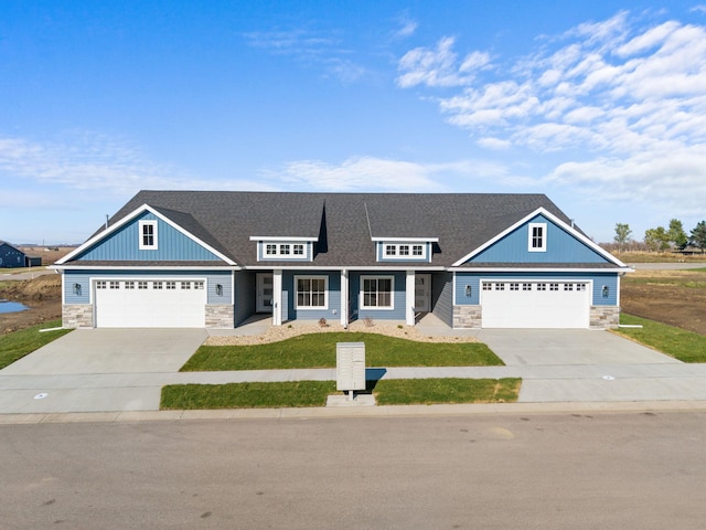 view of front of home featuring a garage, covered porch, and a front lawn