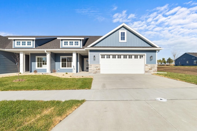 view of front of property with a garage and a front lawn