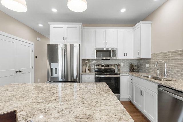 kitchen featuring white cabinets, appliances with stainless steel finishes, and sink