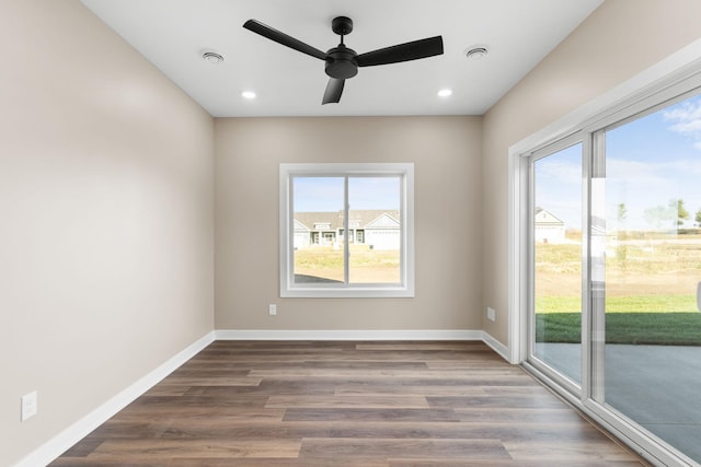 empty room with hardwood / wood-style floors and ceiling fan