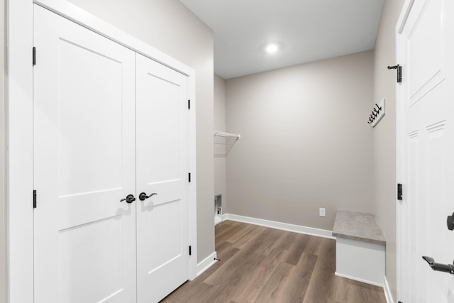 washroom featuring dark wood-type flooring and electric dryer hookup