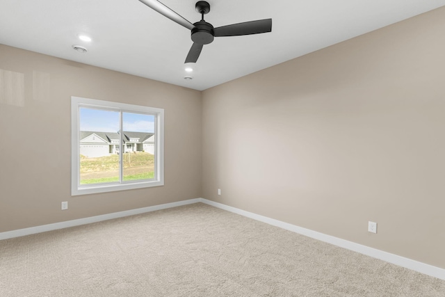 empty room featuring carpet flooring and ceiling fan