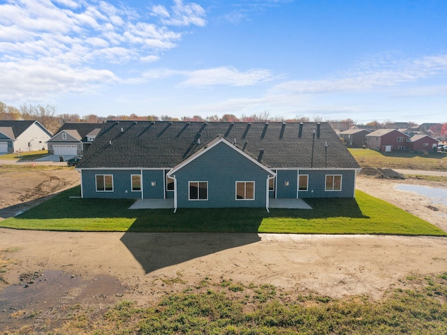 view of front of home with a patio and a front lawn