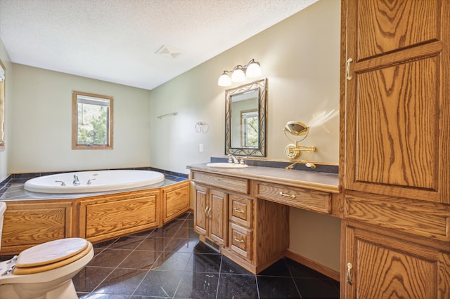 bathroom featuring vanity, a textured ceiling, a tub, toilet, and tile patterned floors