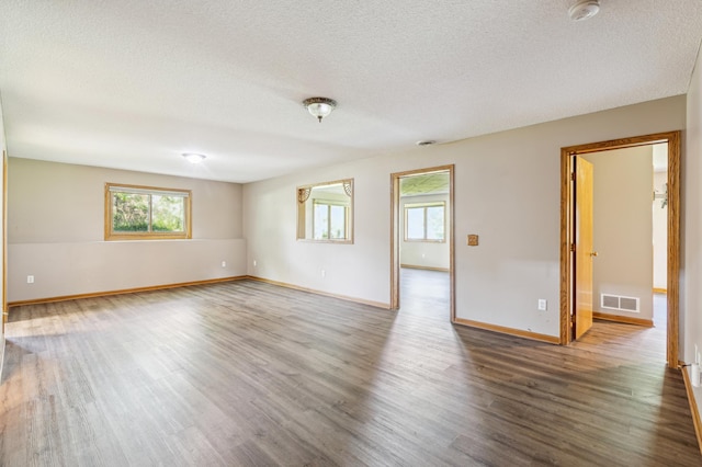 unfurnished room featuring a textured ceiling and wood-type flooring