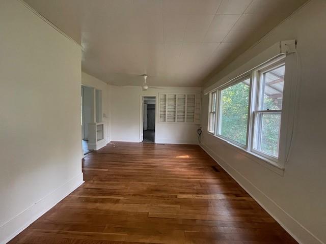 spare room with dark wood-type flooring