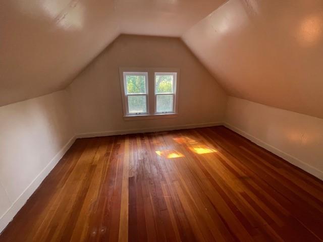 bonus room featuring vaulted ceiling and hardwood / wood-style flooring