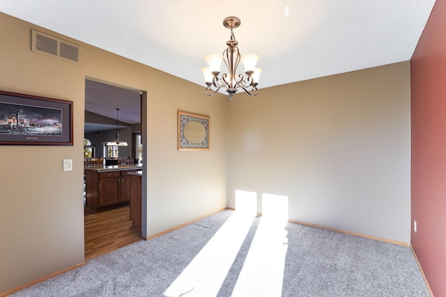 interior space featuring carpet flooring, vaulted ceiling, and a chandelier